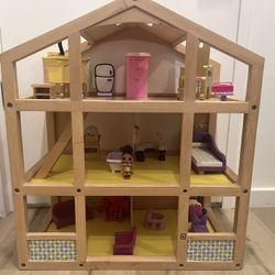 wooden dollhouse with furniture 