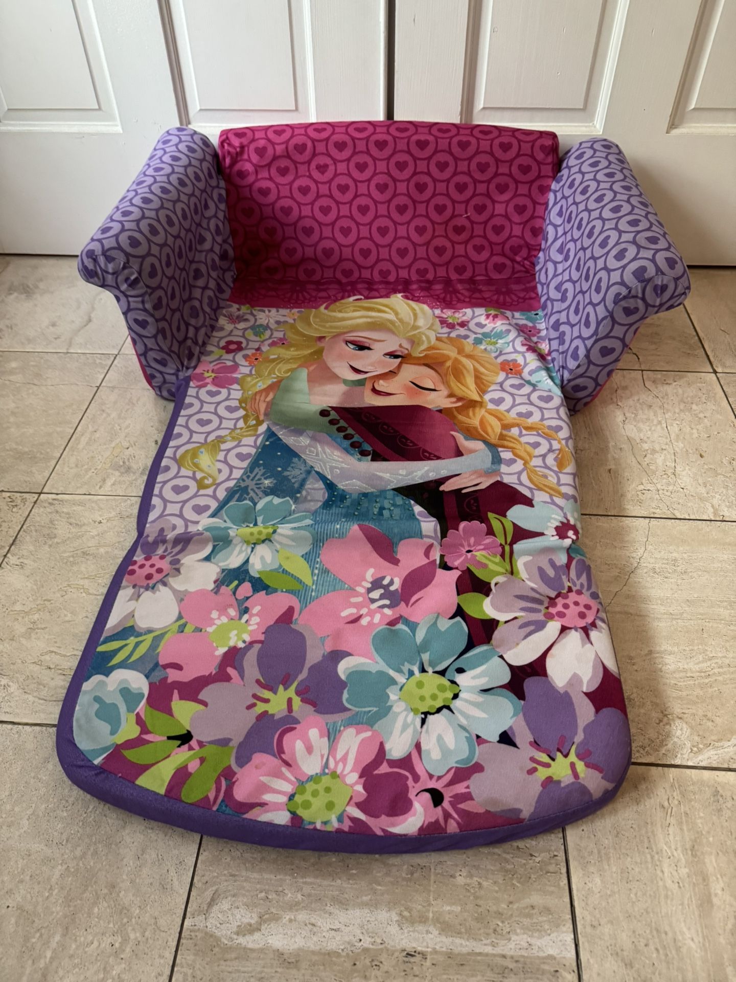 Purple and pink sofa with Frozen characters design.