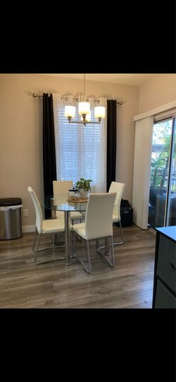 Round glass dining table and four chairs