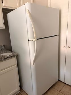 Clean white Frigidaire fridge with ice maker