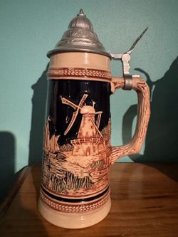 Pre-Owned Vintage German Beer Stein features a relief-style scene of a windmill and sailboats, a Classic Mid-20th-Century design.