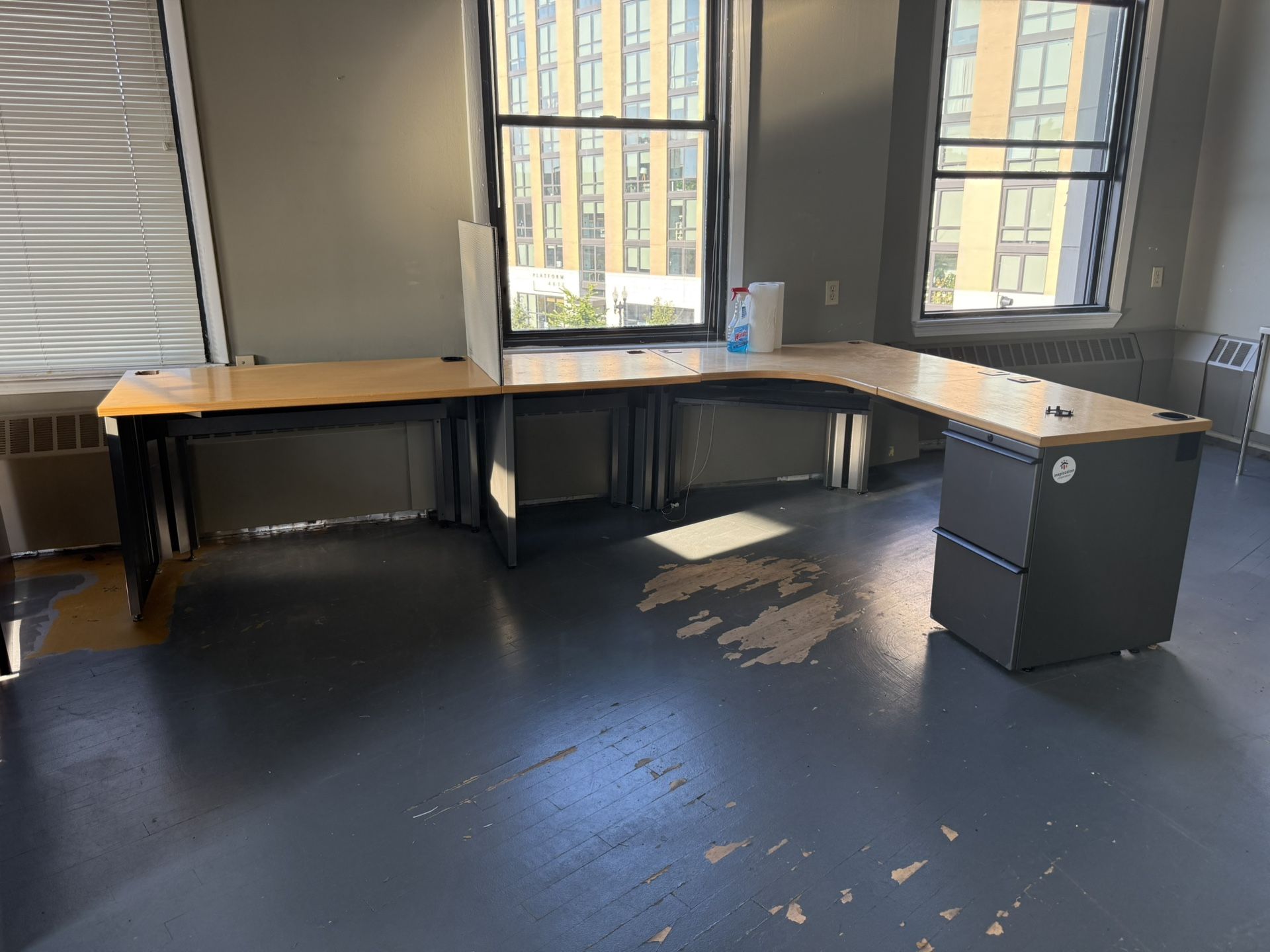 Large office desk with attached drawers.