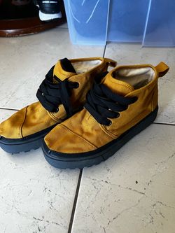 mustard yellow TOMS high-top canvas sneakers