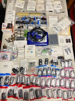 Large haul of Locksmith Supplies/blanks/chips/programmer/garage door remotes/key fabs/tire sensors /various tube locks and mail box/house locks