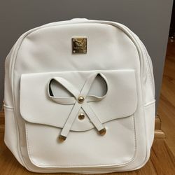 White backpack with tags and a purse with wallet and removable keychain