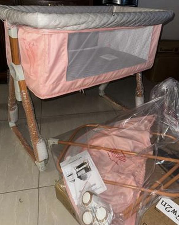 Gray bassinet that hooks up to your bed