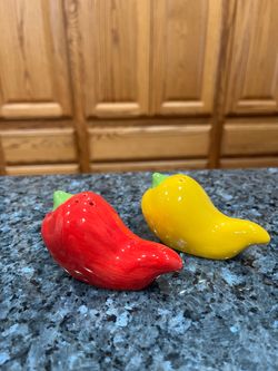Vintage  Red & Yellow Chili Peppers Salt & Pepper Shakers.  Size approximately 2 inches tall and 3 inches long.  Preowned good condition.