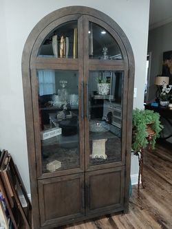 Elegant brown solid wood curio with crystal