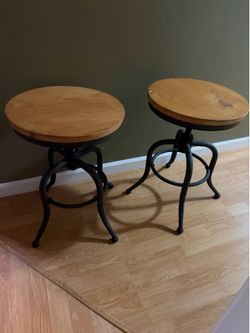 Set of two adjustable swivel counter stools with round wooden seats and metal frame 22”H and 15.75” on the top
