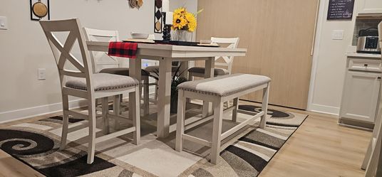 Brand new Height top table with 4 chairs and a bench seat