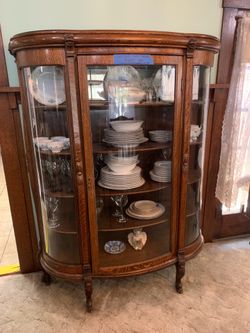 Antique curio cabinet with bubble glass