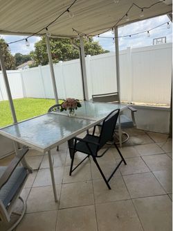 Glass table with two chairs
