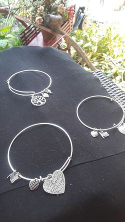 Three nice little silver adjustable bracelets charms are different sayings on them $5 a piece