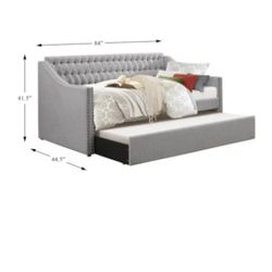 Grey twin day bed with trendle  underneath