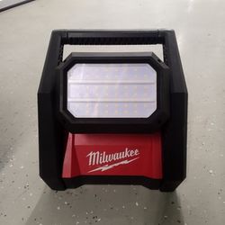Milwaukee spotlight can use a M18 battery or be plugged into a normal house outlet works great