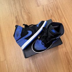 This is a Nike Air Jordan 1 Retro High OG 'Royal Reimagined' sneaker in black and royal blue suede.  Size 10c