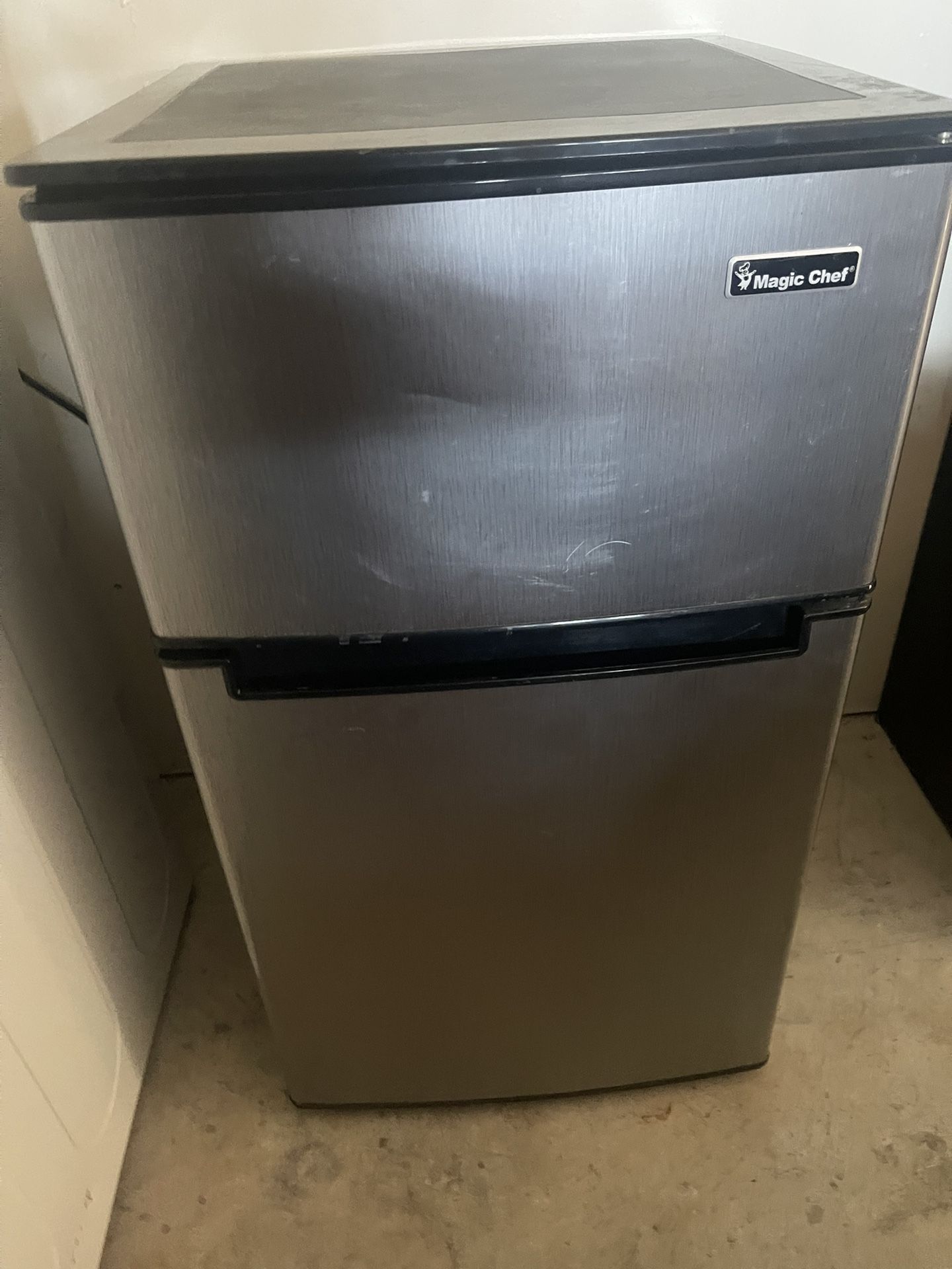 Grey, black Magic Chef mini fridge With Freezer On Top.