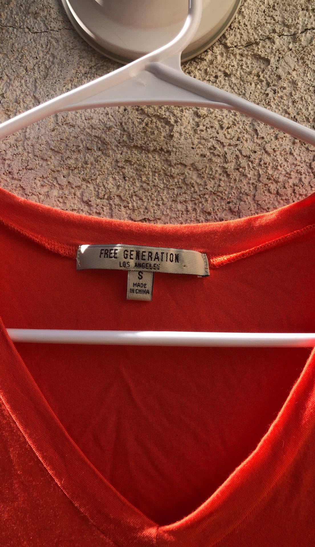 Women’s small orange V-neck top