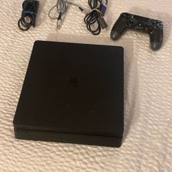 Playstation 4, Black Slim And A Controller With All The Cords