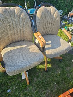 Two comfy swivel chairs with wood accents. Never used