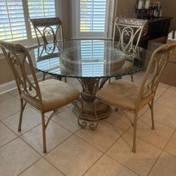 Gorgeous Wrought Iron Very Solid Dining Set. 54” round 30” height. Great condition glass top & 4 Chairs