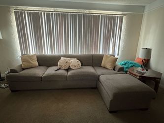 Large Gray Sectional Couch & Patterned Ottoman + Solid Wood Side Table Set