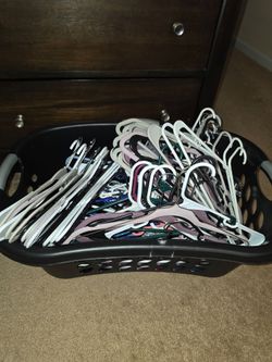 Laundry basket with a bunch of hangers