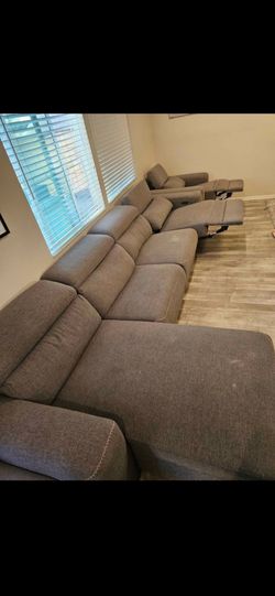Gray reclinable electric couches.