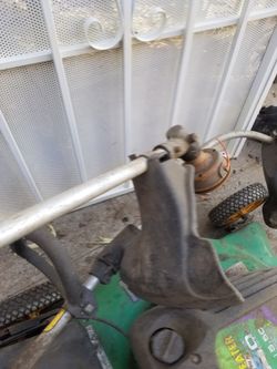 2 Weed Trimmers And 1 Lawnmower