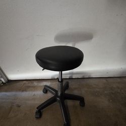 Adjustable stool with wheels.