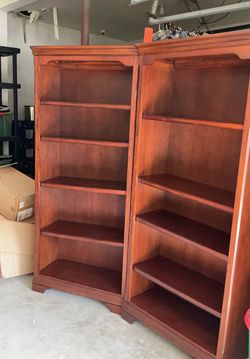 A pair of sturdy wooden bookcases with adjustable shelves – .