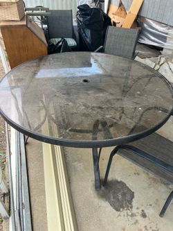 Large 60” round glass top aluminum frame patio table and 7 chairs