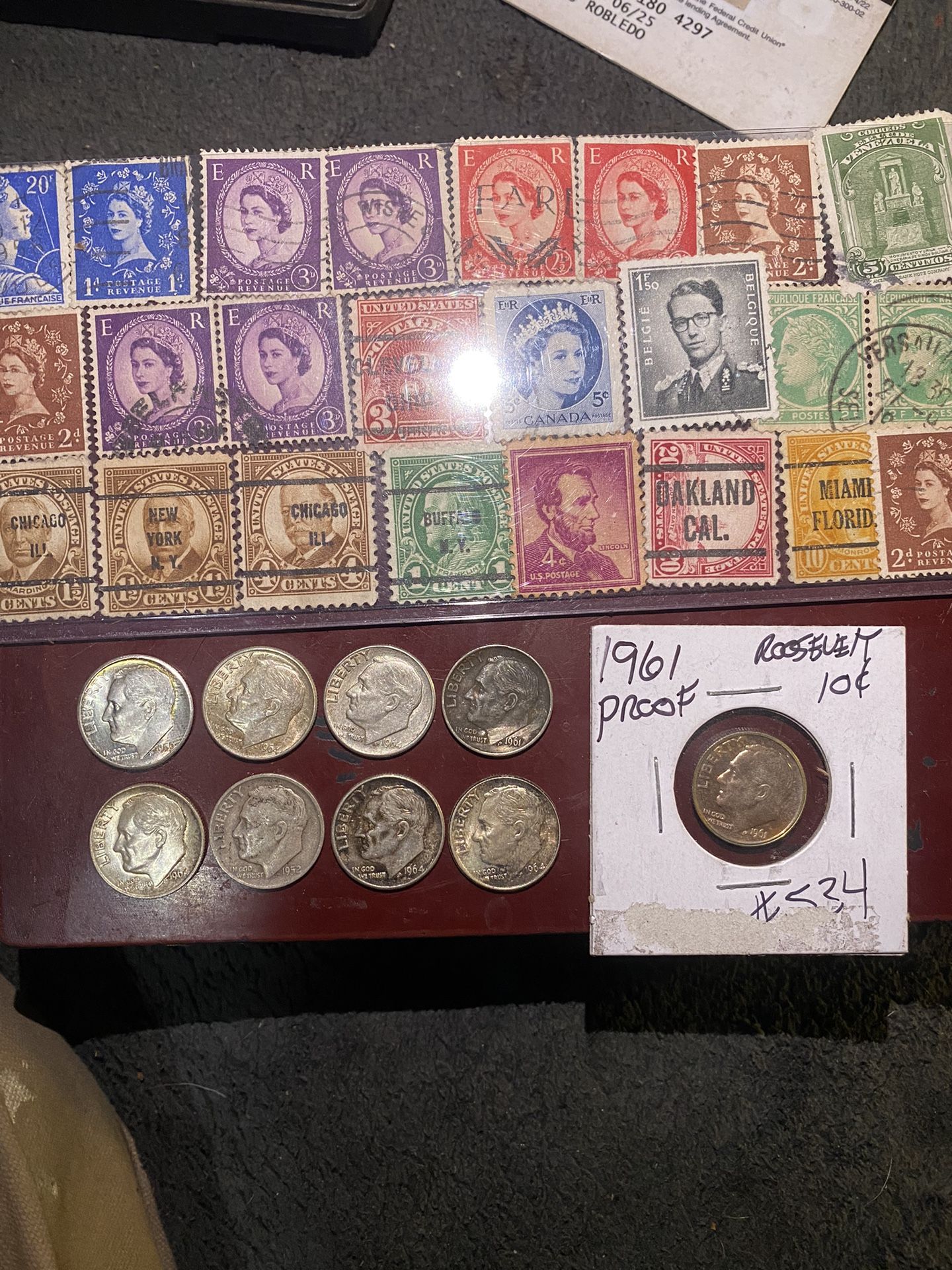 Nine silver Roosevelt, dimes, one 1961 proof and some used and unused old stamps