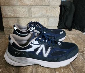 New Balance 990v6 sneakers in a navy and white colorway featuring the iconic "N" logo on the side.