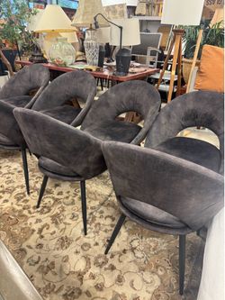 Set of 8 curved, open-back design upholstered in grey velvet with black metal legs