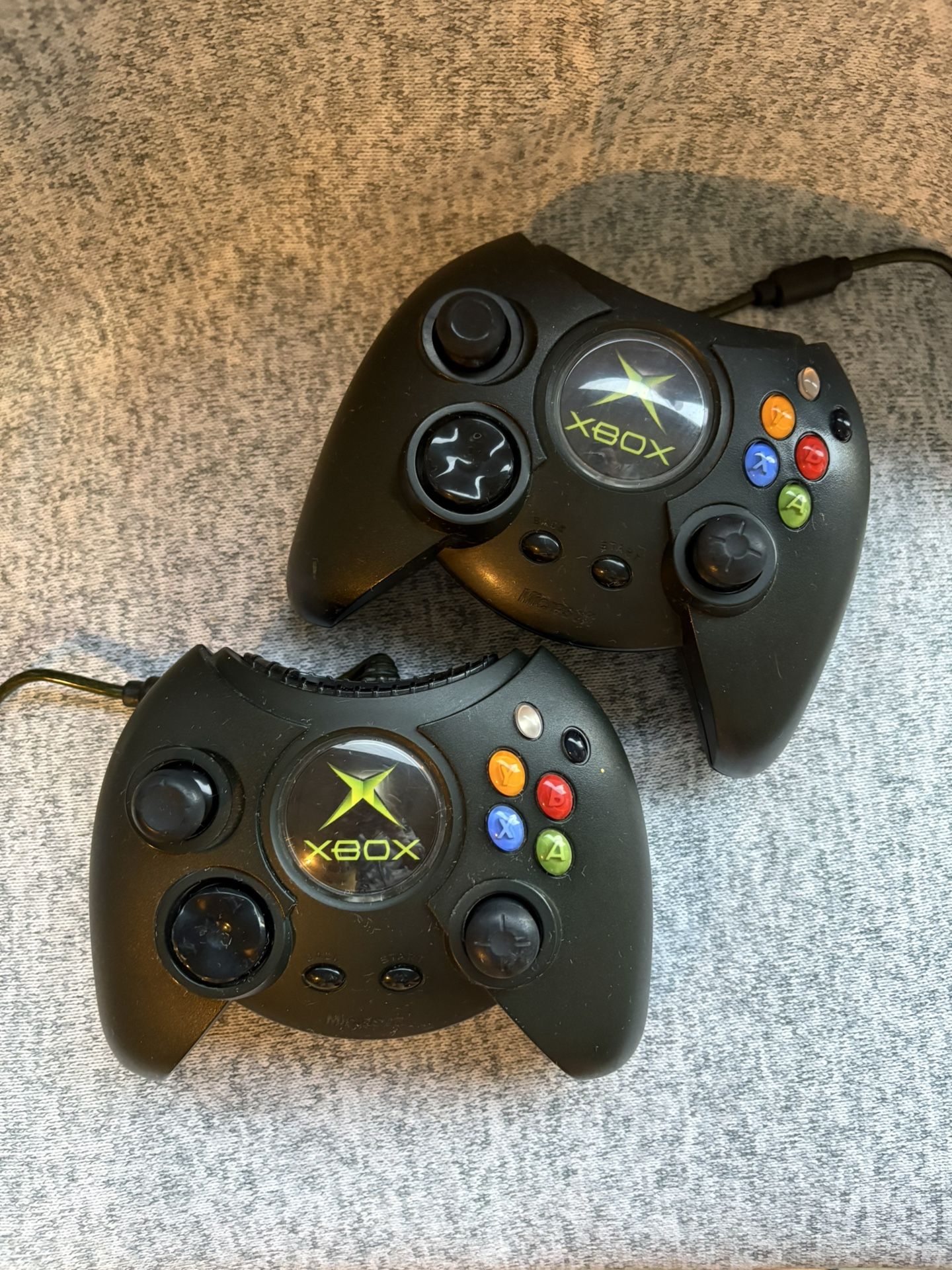 Two black Xbox Wireless Controllers