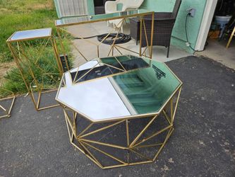 3 gold tables with glass tops