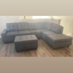 BRAND NEW REVERSIBLE SECTIONAL SOFA WITH STORAGE OTTOMAN AND DROP DOWN CUP HOLDERS 