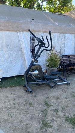 Elliptical exercise machine everything works well good condition clean Sunny brand  comes with wheels