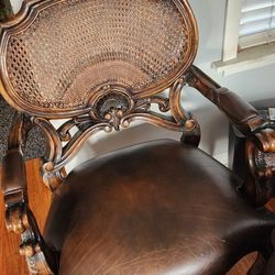 Elegant Upholstered Chair with Cane Back and Padded Arms