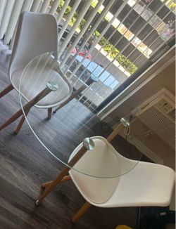 White dining chairs with glass table
