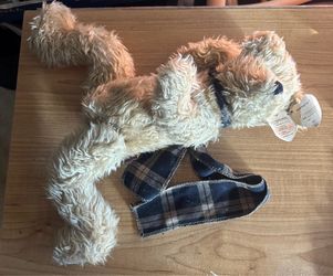 vintage Ty Attic Treasures Bearington plush bear from 1993, featuring shaggy light brown fur and a dark blue plaid ribbon bow around its neck.