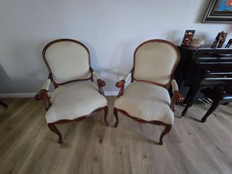 Pair of carved wood arm chairs