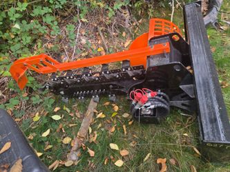Skid steer trancher atachment for tranch