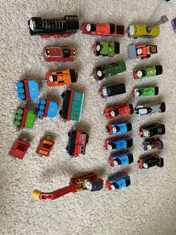 21. Metal Thomas the Tank Engine engines with a couple pull behind trailers.