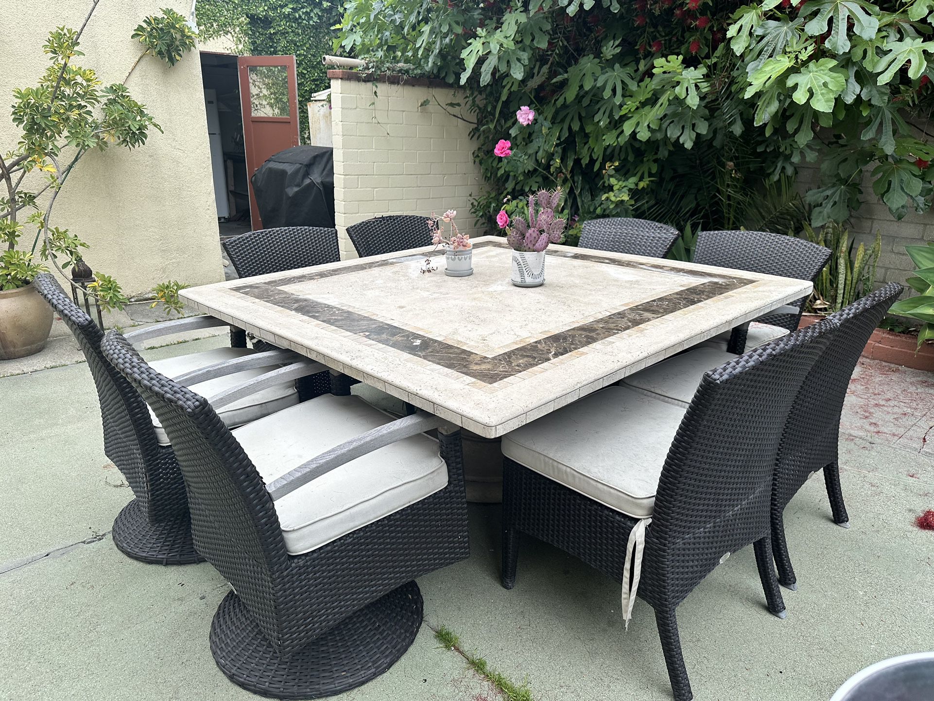 Massive marble outdoor patio dining table with 8 wicker chairs