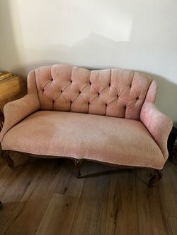 Pink antique loveseat