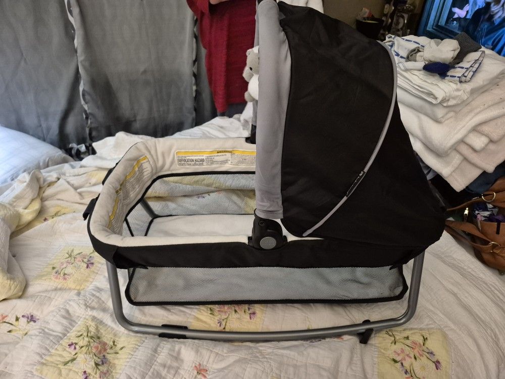 Baby Trend Bassinet, Changing Table, and Diaper Accessory Organizer.