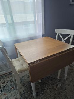Ikea expandable table with 2 wooden chairs