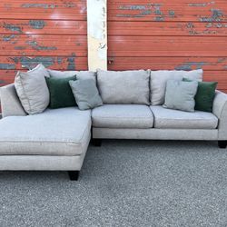 Gray sectional sofa couch with left facing chaise